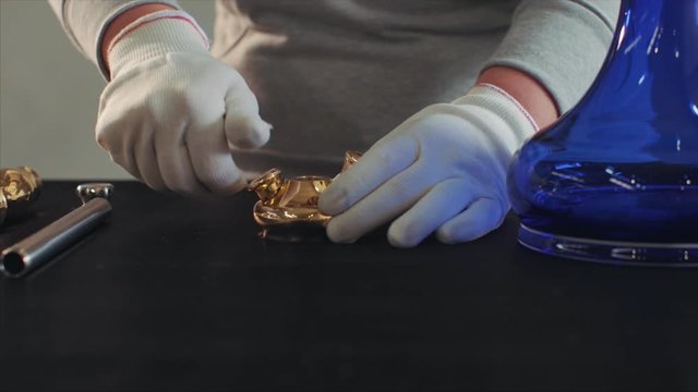 In hookah production, women combine hookah pieces.