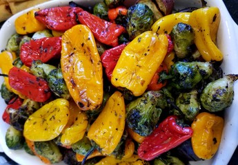 Oven roasted red and yellow sweet peppers and brussels sprouts