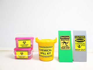 Chemical Spill kit yellow bucket and Biohazard Spill Kit with Warning danger caution hazard tag sign or symbol for emergency response situation when the chemical spill out, safety first in laboratory.