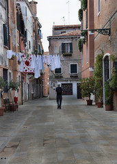 Solo senior tourist on the non-touristy street in Venice.