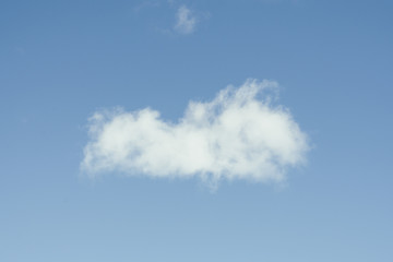 Single cloud flying in the deep blue sky
