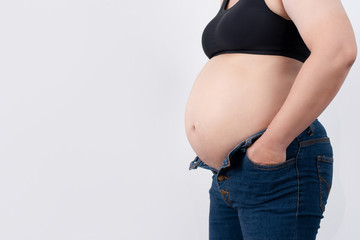 Closeup of a pregnant woman. And isolated white background in the studio.