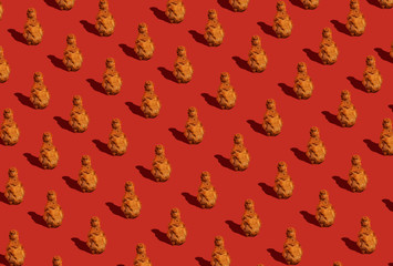 Fried chicken leg with sauce on a red background. Food pattern