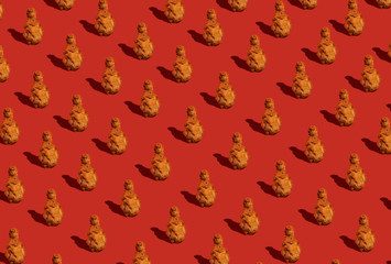 Fried chicken leg with sauce on a red background. Food pattern