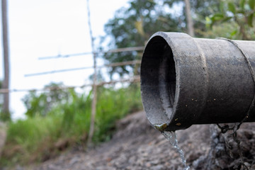 The cement drainage pipes allow waste water to flow through.  Behind industrial plants  After the ...