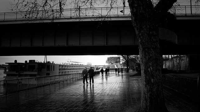 People Walking On Footpath Under Bridge