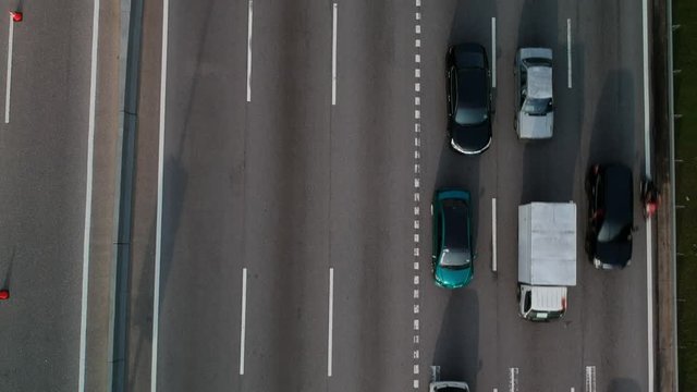 Aerial top down view of a busy highway during rush hour.