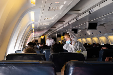MIAMI, USA - APRIL 26, 2020: Covid 19 coronaviruse. Stewardess in protective mask on the plane board. Evacuation repatriation. Flying during coronaviruse pandemic. Special flight returns US citizens. - 346358764