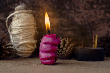 Fototapeta na wymiar Burning candle in the shape of a hand