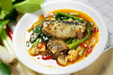 Sardines in tomato sauce with vegetable spicy thai herb curry ingredients.