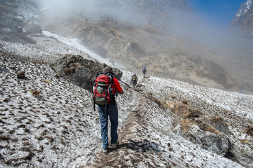 Group of trekkers walking on the snowfield after avalanche in Annapurna Sanctuary of Nepal. Annapurna Sanctuary Trek is most popular trek destination of Annapurna region.