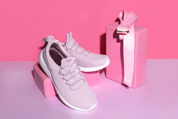 New purple sneakers, pink yoga blocks and strap on colorful background with copy space. Healthy lifestyle concept.