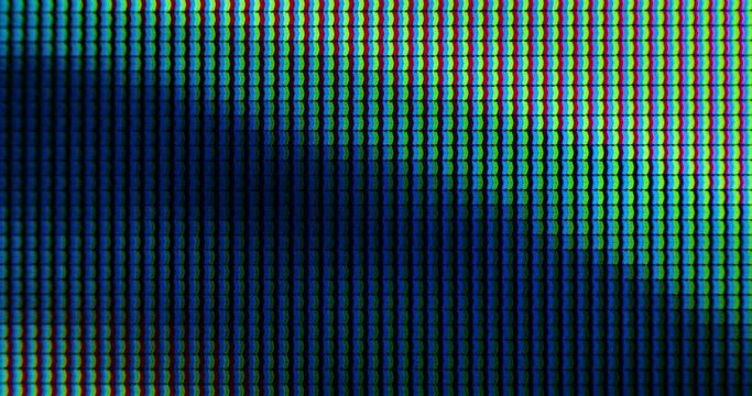 Extreme Close up of Television Screen Pixels, RGB LEDs are Blinking Lights and Emitting Photons from TV