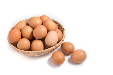Eggs in a wooden basket on a white background.
