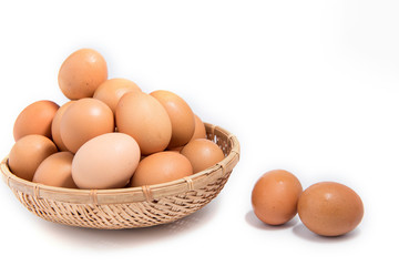 Eggs in a wooden basket on a white background.