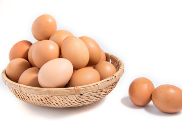 Eggs in a wooden basket on a white background.