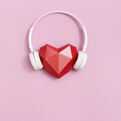 Volumetric paper heart in white headphones.  Concept for music festivals, radio stations, music...
