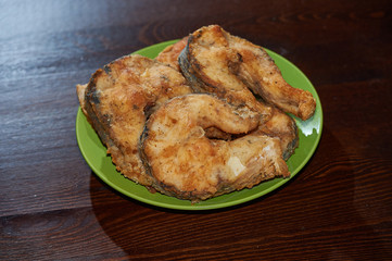 Fried fish slices on a plate. Fried pike. Fried pike slices.
