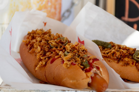 Sausage Hot Dog During Fast Food Festival Event. Outside Catering Or Outdoor Party Grab And Go Dish