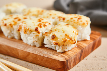Baked shrimp rolls on wooden board top view
