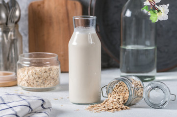 Homemade oat milk on light background