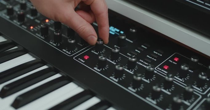 Close-up of hand playing with knobs