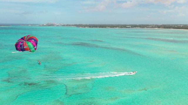 Colorful Parasailing Parachute Over Turquoise Tropical Sea. Bahamas Luxury Holiday Activity
