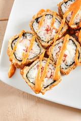 Rolls with shrimps, cream cheese, tomatoes and Spicy sauce in white plate top view