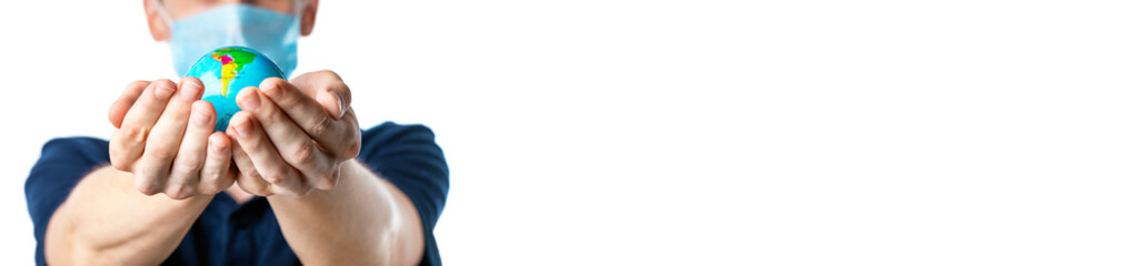 Banner. Close-up of a man's hands holding a globe, with images South America: Brazil, Uruguay, a man in a medical mask out of focus, dressed in a t-shirt, on a white isolated background. Coronavirus