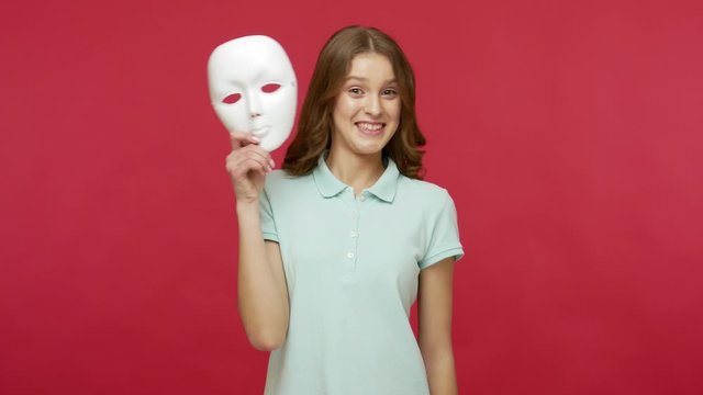 Impostor, hypocrisy in communication. Young brunette woman in polo t-shirt removing face mask and expressing various emotions as surprise, joy, sadness, anger. studio shot isolated on red background