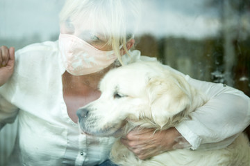 Coronavirus outbreak. Woman with dog staying at home in quarantine..