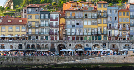 Fototapeta na wymiar Portugal cityscape by the river with tourist (blurred face) hanging out