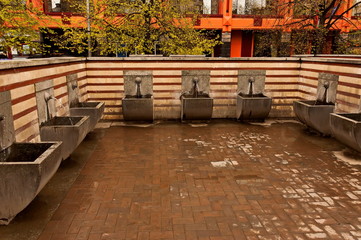 Naklejka premium Hot mineral spring water, leaks from several pipes in a purpose-built public place, Sofia, Bulgaria, Europe 