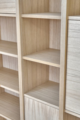Fototapeta na wymiar Wooden bookshelves. Wooden bookcases and wall panels made of oak veneered MDF