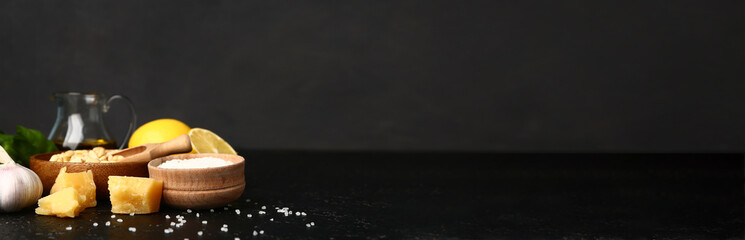 Ingredients for pesto sauce on dark background with space for text