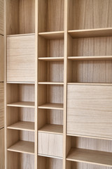 Wooden bookshelves. Wooden bookcases and wall panels made of oak veneered MDF