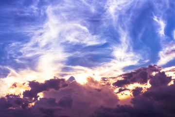 Lighting clouds on overcast blue sky