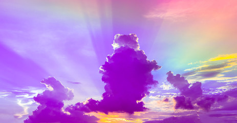 Purple clouds with rainbow light in twilight sky