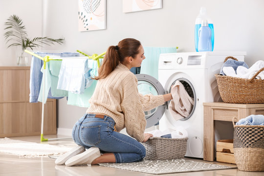 Young Woman Doing Laundry At Home