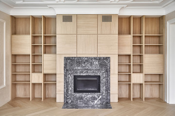 Wooden bookcases and wall panels around the fireplace
