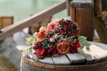 Floral arrangement of red pomegranate flowers with pink and white roses