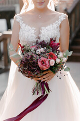 Lush and unique bridal bouquet of pink and white roses with hydrangea and silver penny eucalyptus leaves, creeper berries, amaranthus flowers