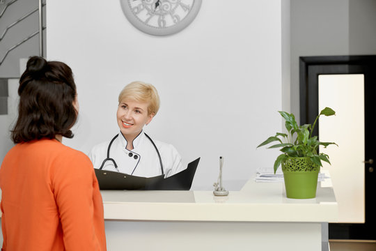 Patient And Doctor Talking On Reception.