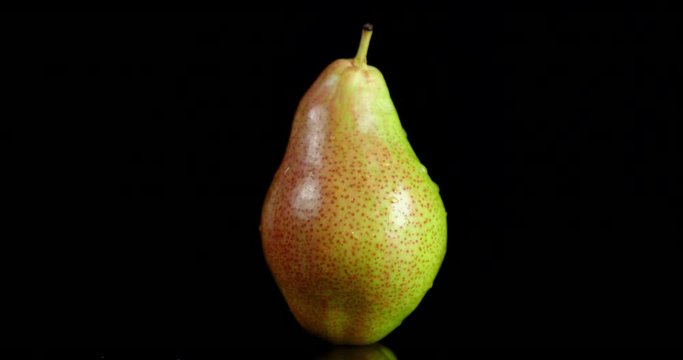 One fresh pear slowly rotates.