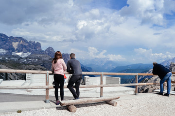 couple looking for amazing mountains view. Dolomites, Italy. 