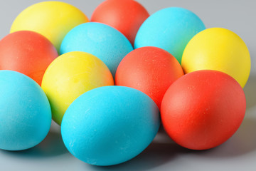 Colorful Easter eggs on a gray background. Easter eggs background. Easter eggs are a symbol and a mandatory attribute of the holiday.