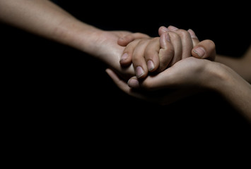 Fototapeta premium Mother and daughter holding hands. Helping hands.