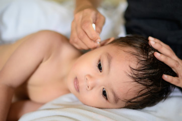 Fototapeta na wymiar Cleaning small baby ears