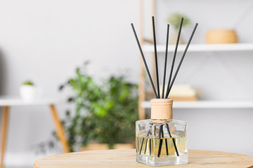 Reed diffuser on table in room