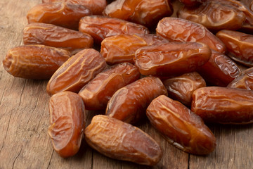 Close up of cluster dates plam. Fresh dates plam on wooden table.